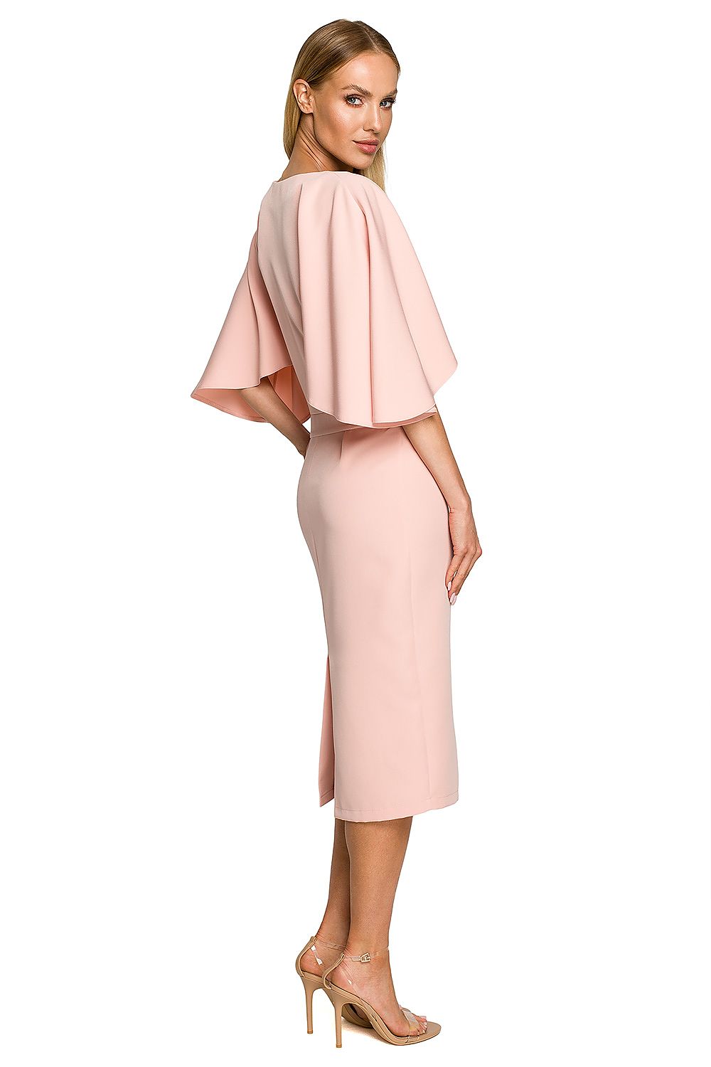 Woman wearing a pink dress with cape sleeves on a white background