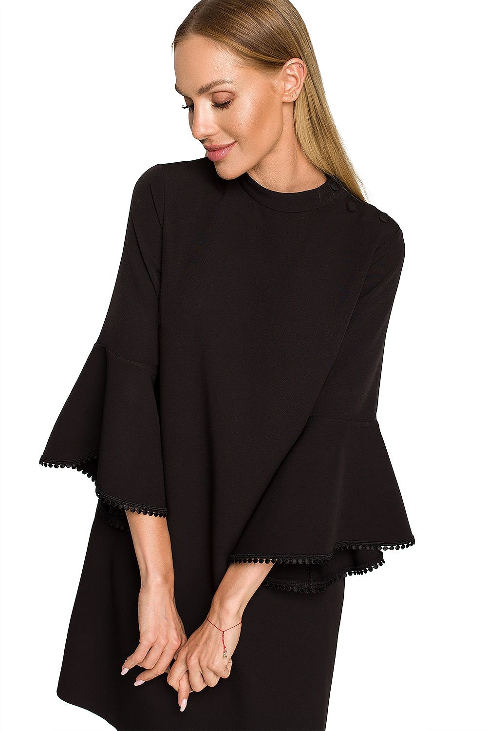 Woman wearing a black dress with bell sleeves on a white background