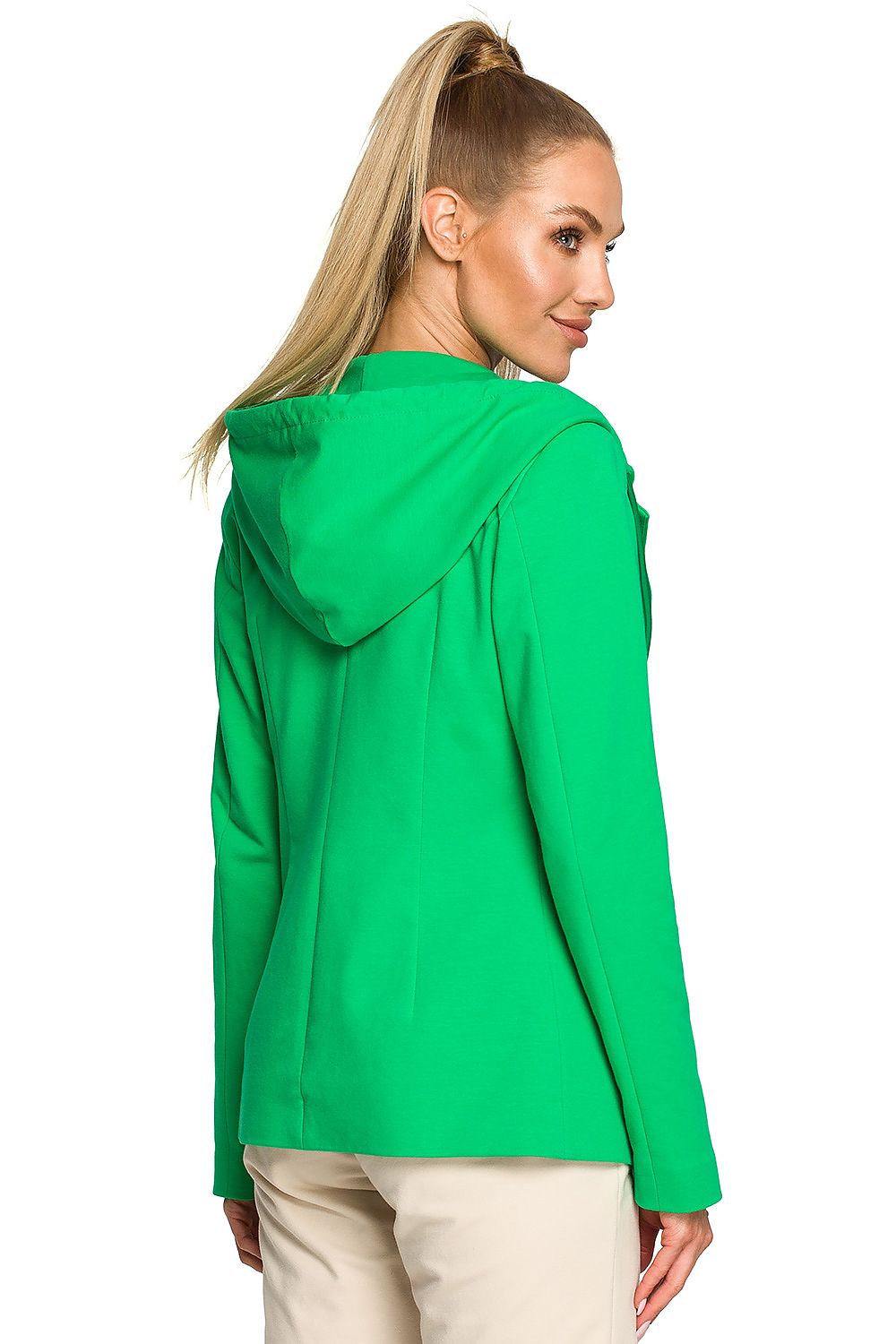 Woman wearing a green jacket on a white background