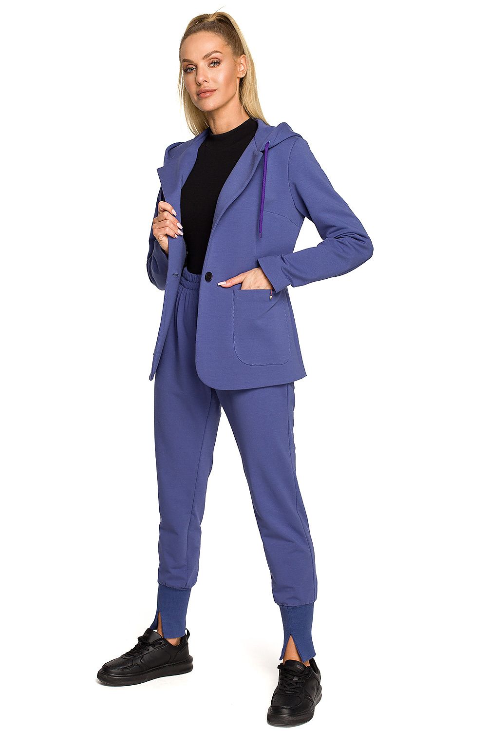Woman wearing a blue suit with a black top on a white background
