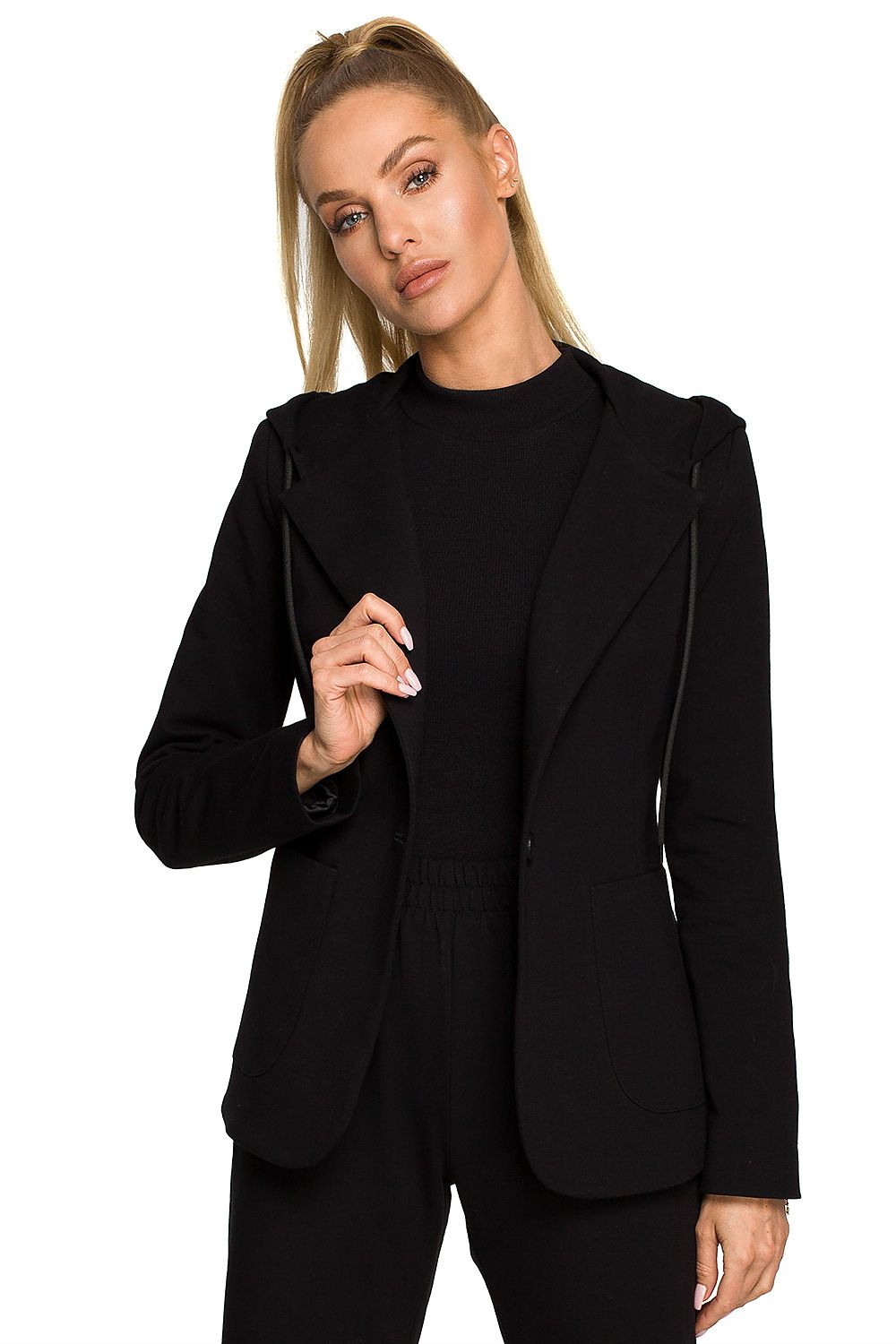 Woman wearing a black blazer and pants on a white background