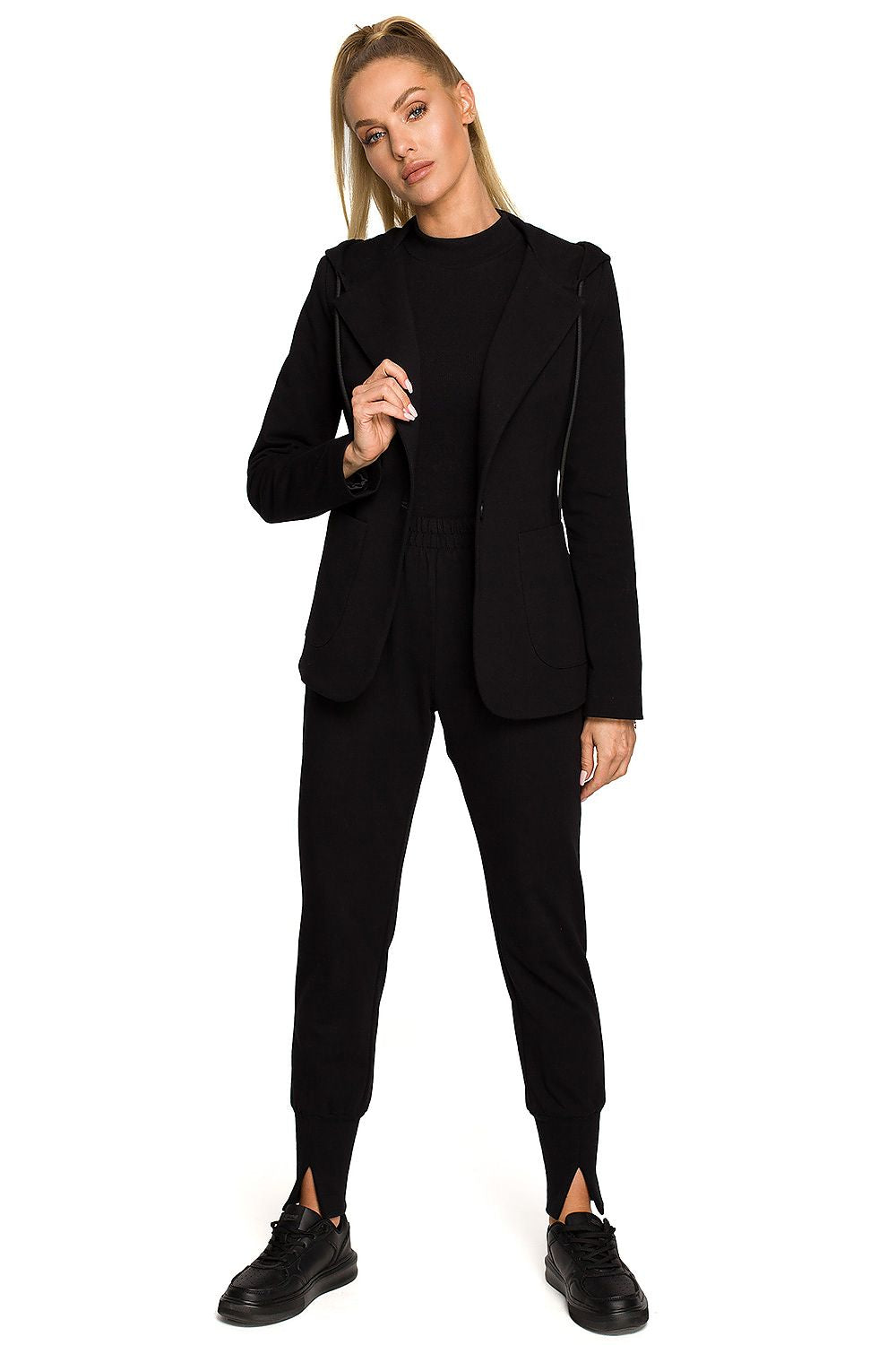 Person wearing a black suit on a white background