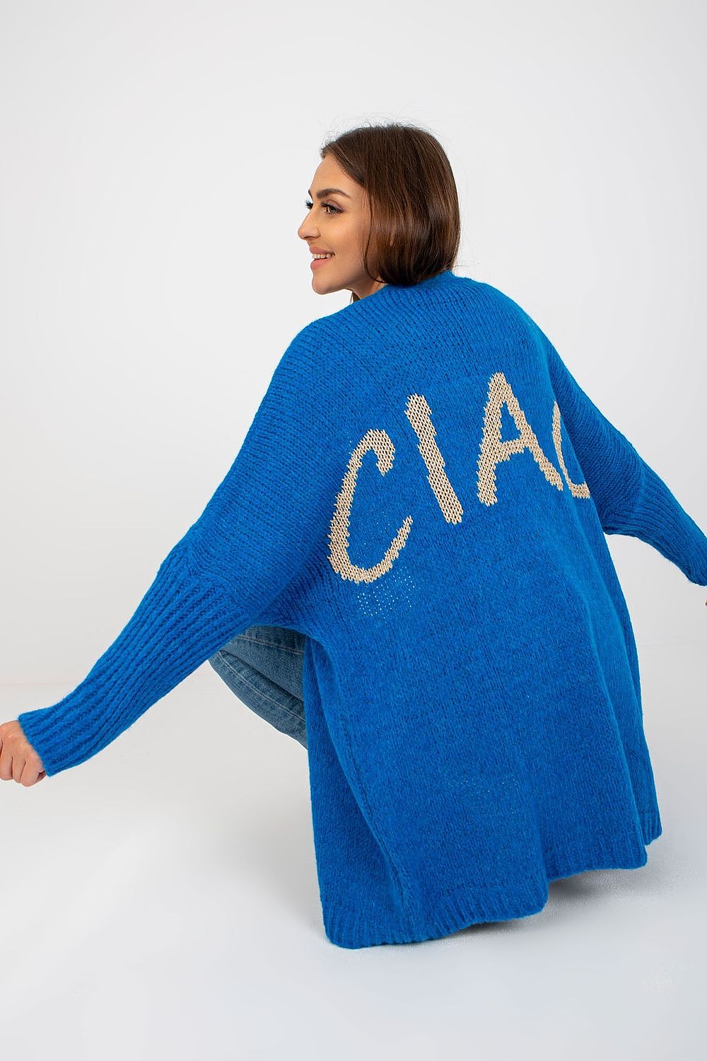 Woman wearing a blue cardigan with 'CIAO' text on a white background