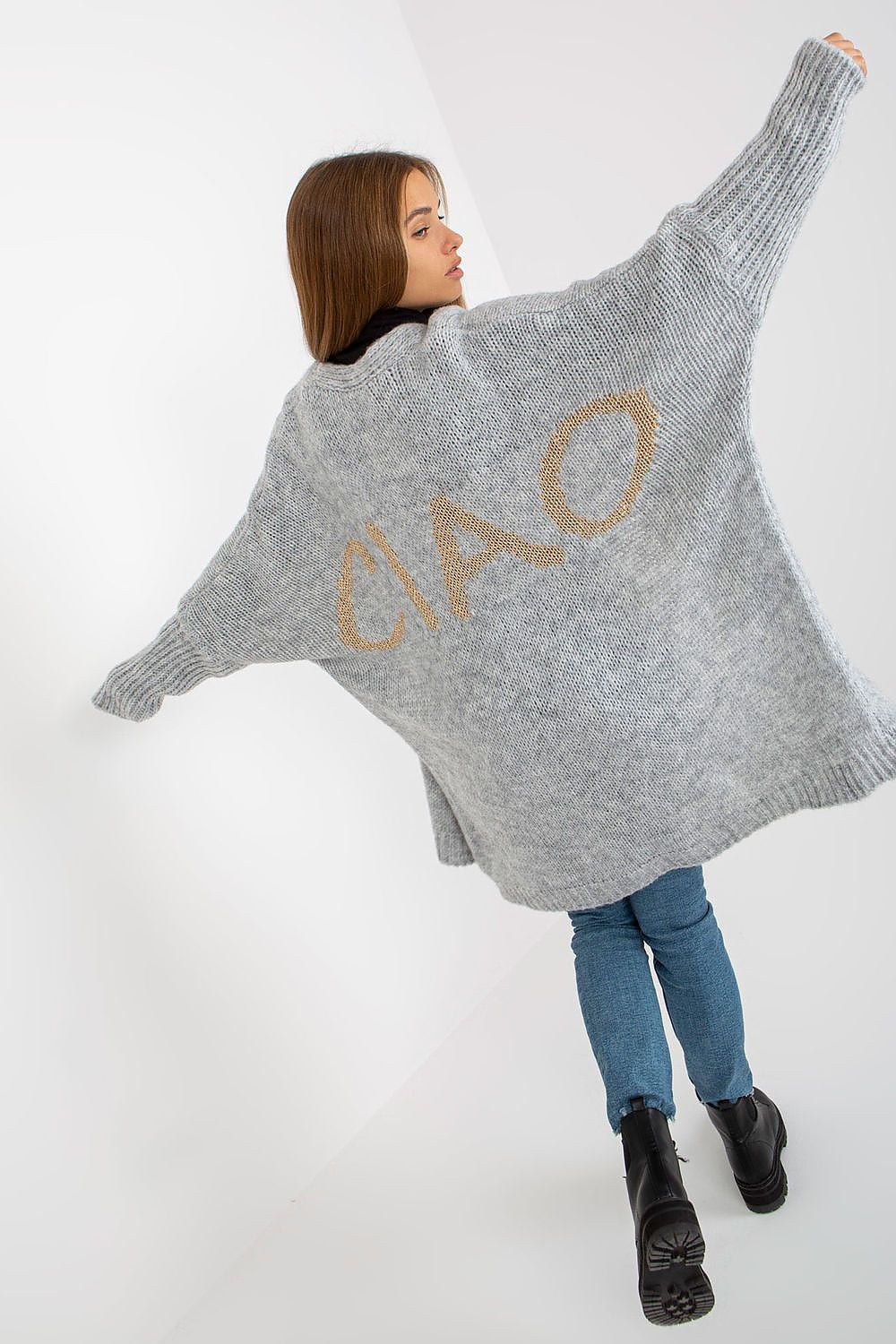 Woman wearing a gray cardigan with 'Ciao' text on a white background