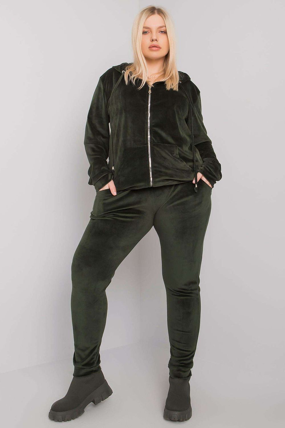Person wearing a black tracksuit against a white background