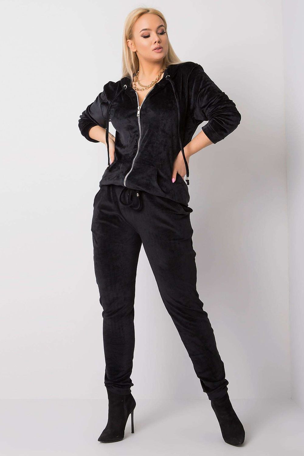 Woman wearing a black tracksuit on a white background