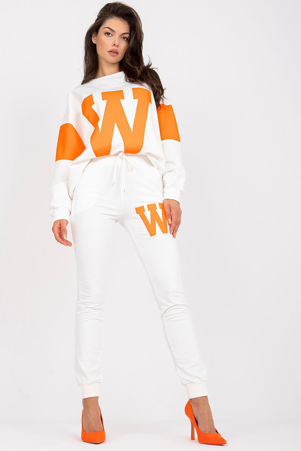 Woman wearing a white and orange outfit with 'W' logo on a white background