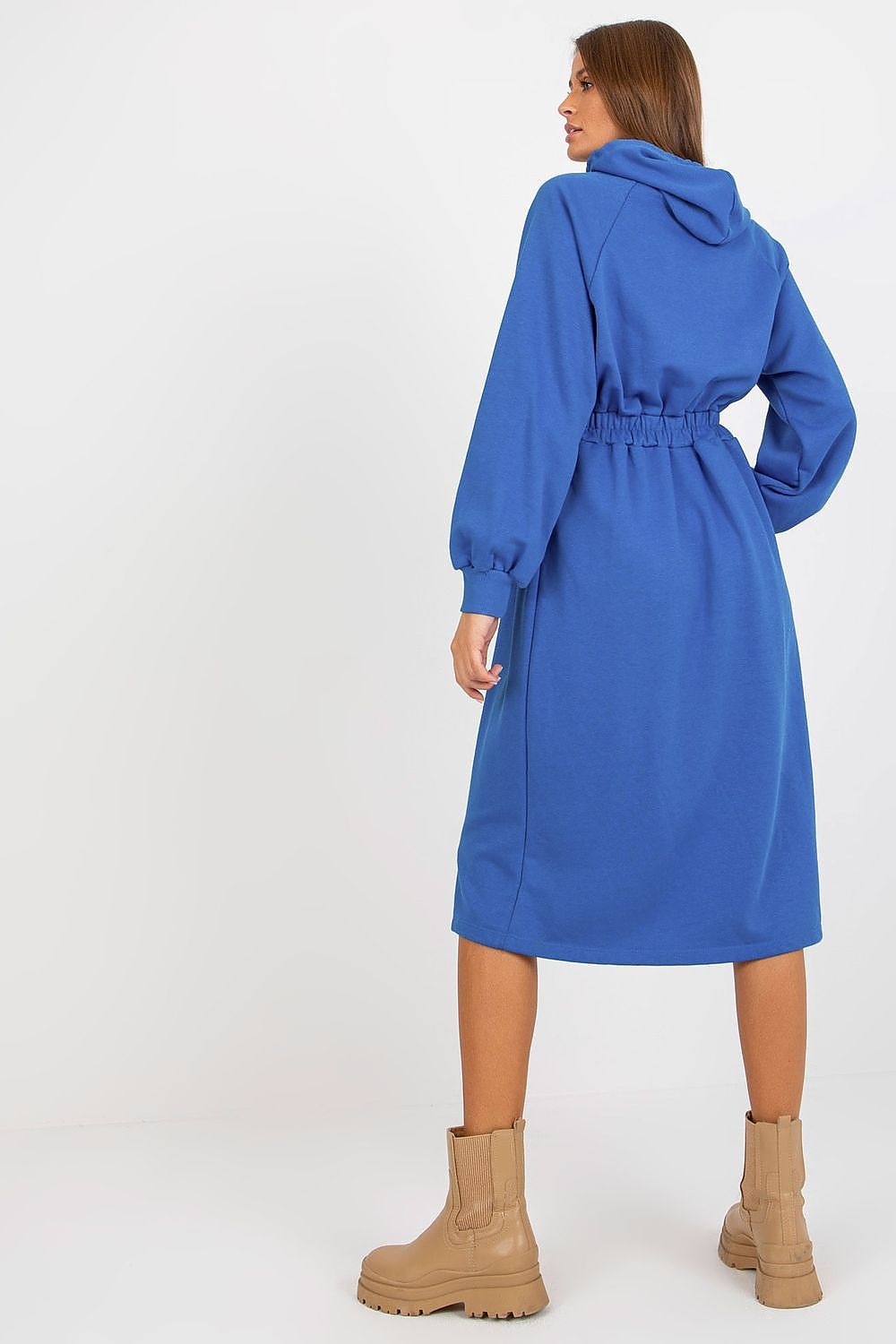 Woman wearing a blue coat with a white background