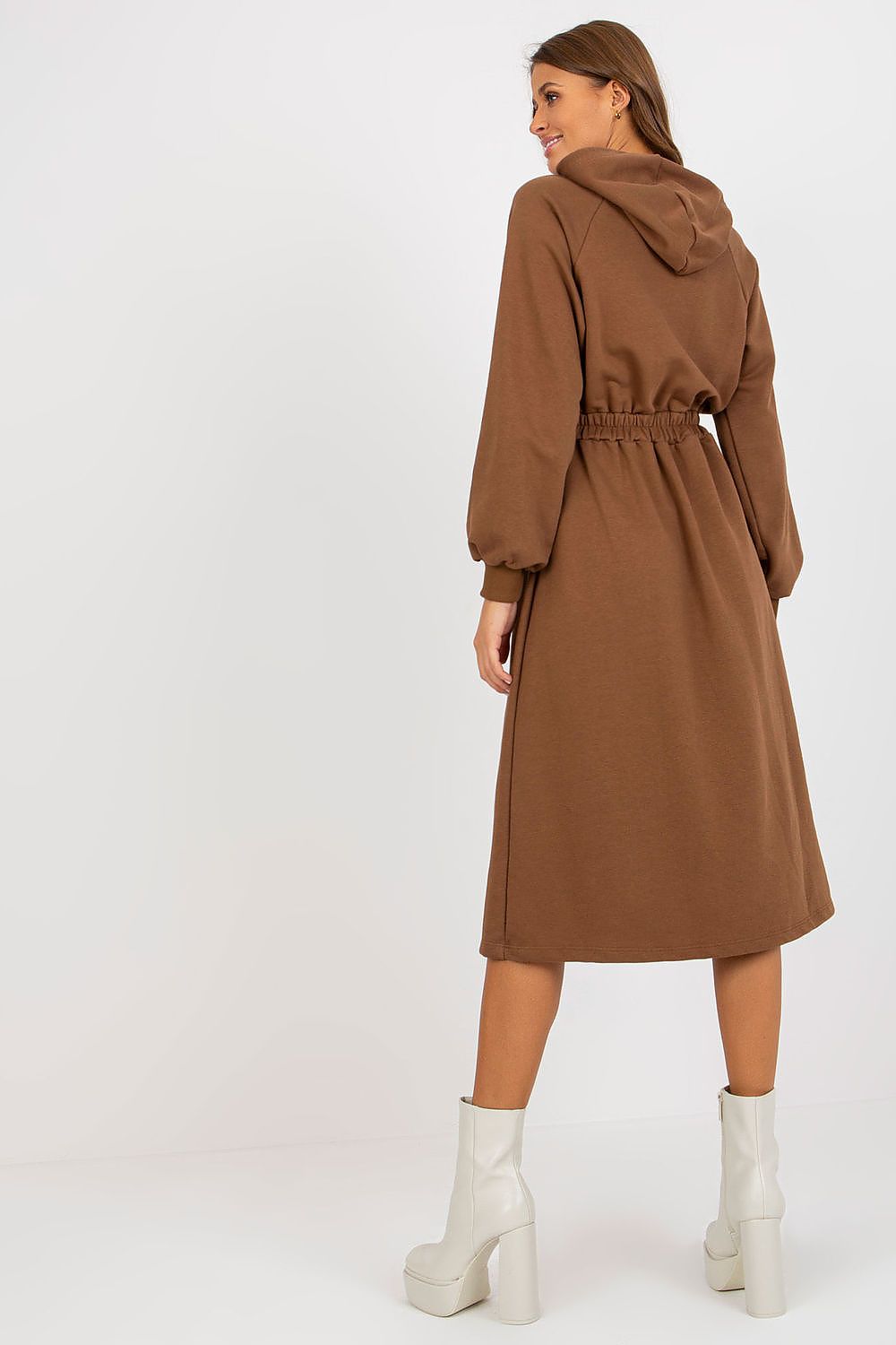 Woman wearing a brown coat with a white background