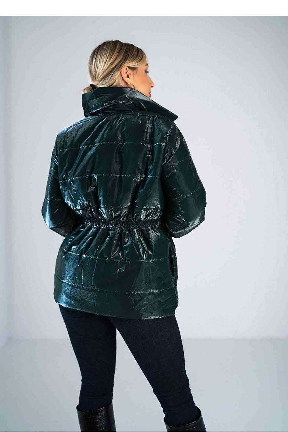 Person wearing a green puffer jacket on a plain background