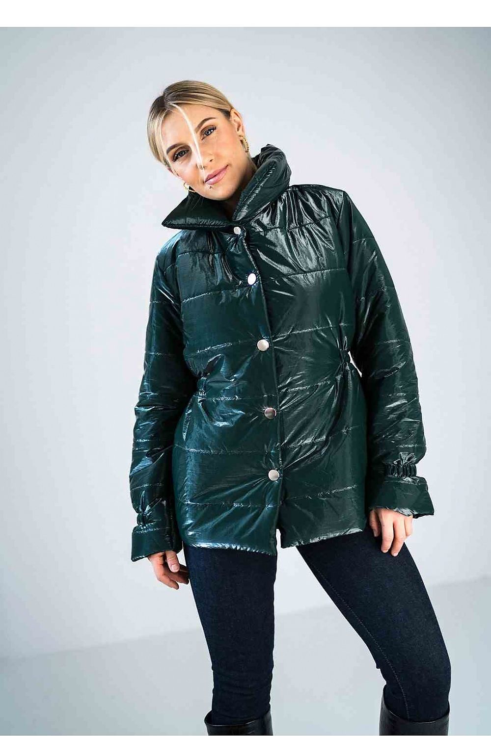 Person wearing a green puffer jacket on a light gray background