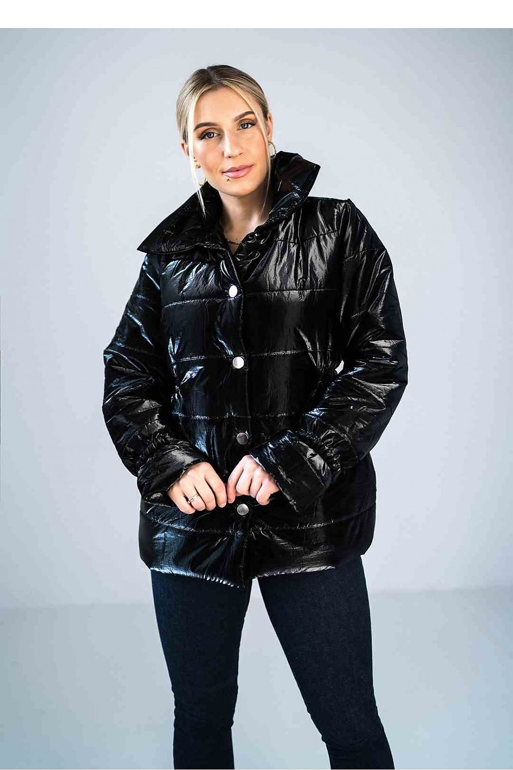 Person wearing a black puffer jacket against a plain background