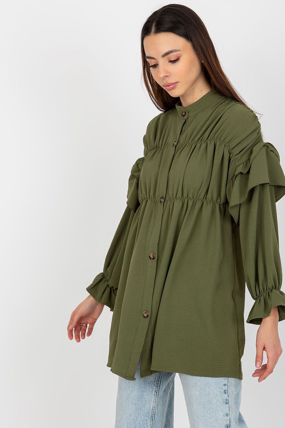 Woman wearing an olive green blouse with ruffled sleeves on a white background