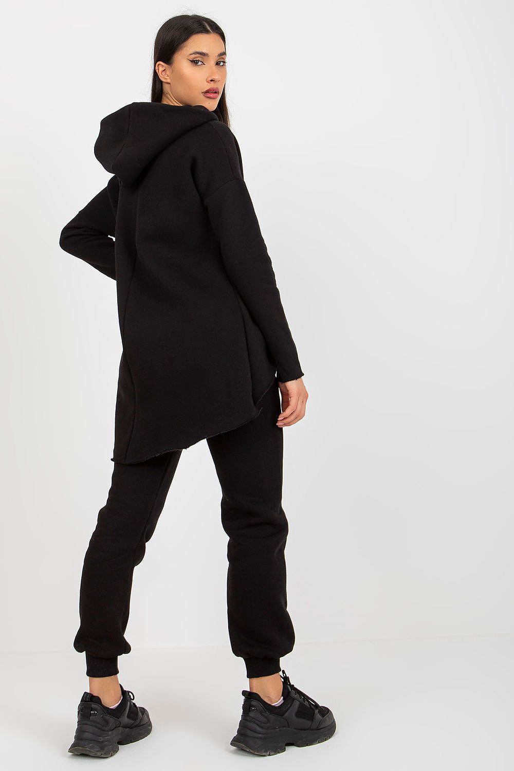 Side view of black women’s hooded sweatshirt and pants with waist tie