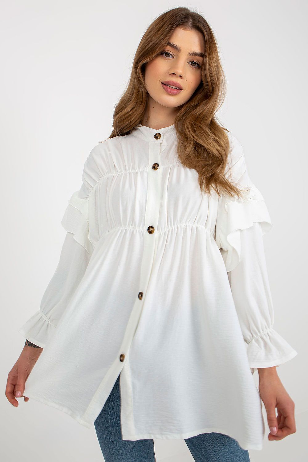 Woman wearing a white blouse with brown buttons on a white background