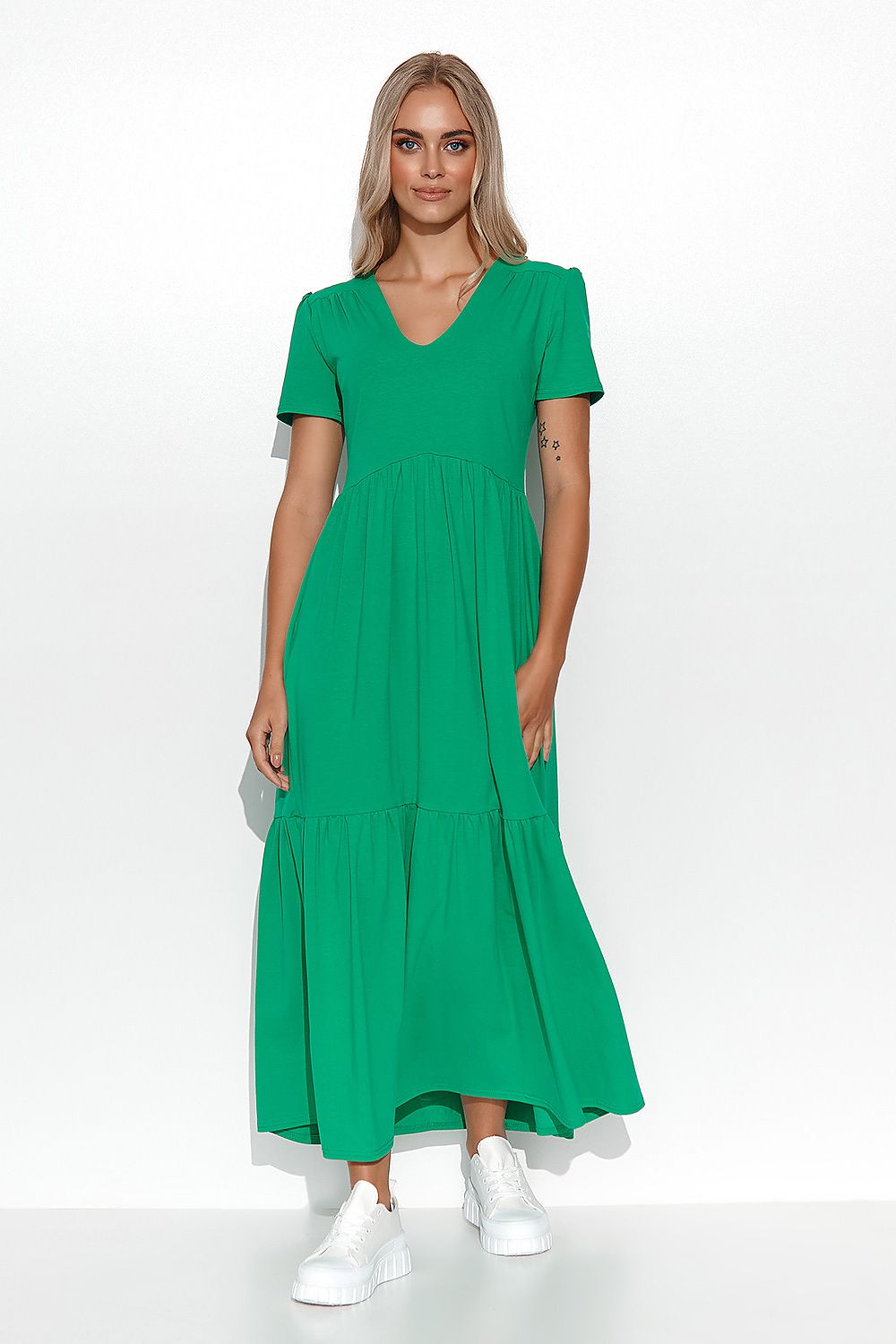 Woman wearing a green dress on a white background