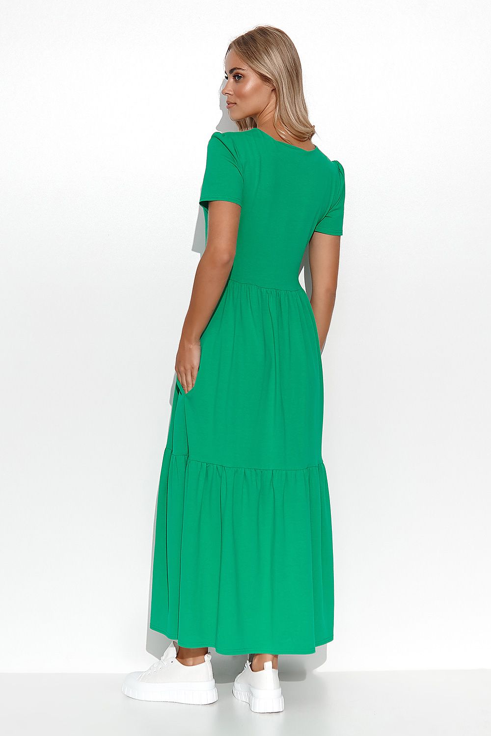 Woman wearing a green dress on a white background