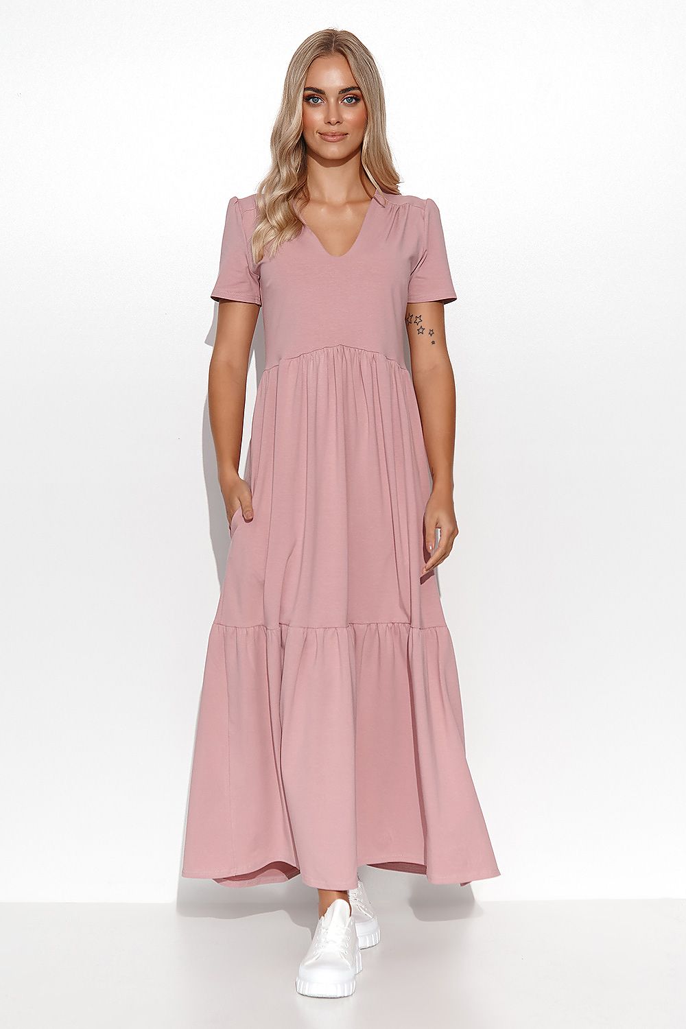 Woman wearing a pink dress on a white background