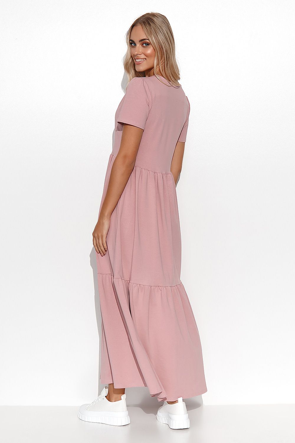 Woman wearing a pink dress on a white background