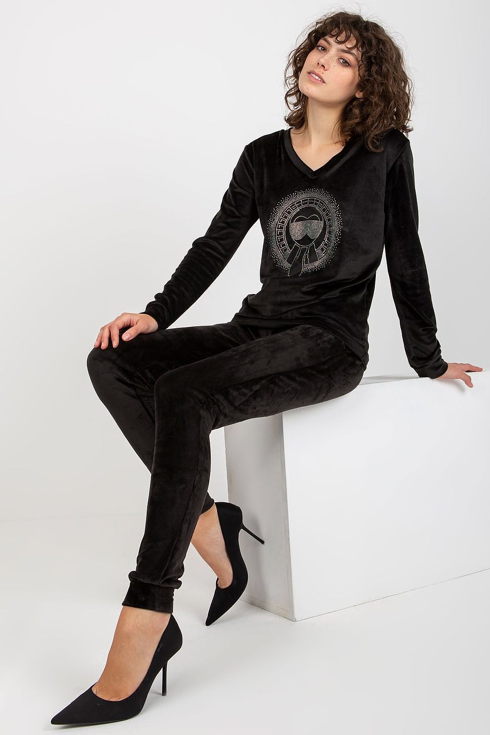Woman wearing a black outfit with a graphic design on a white background