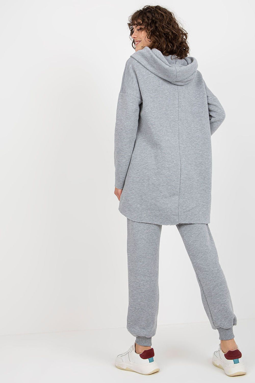 Side view of beige women’s hooded sweatshirt and pants with waist tie