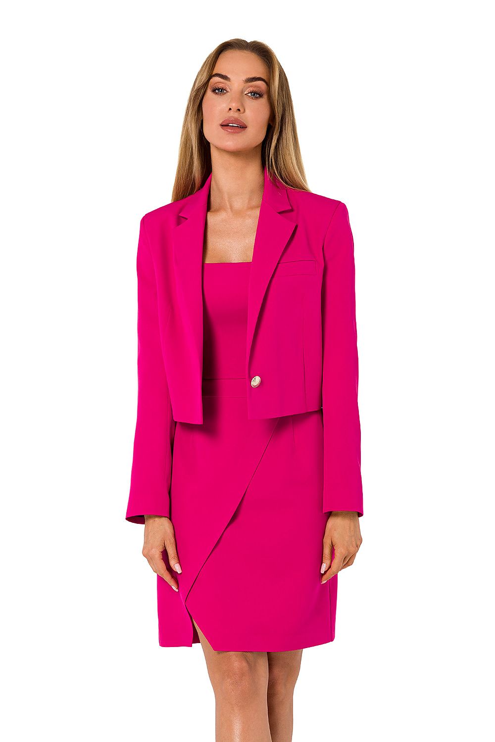 Woman wearing a bright pink suit with a matching dress on a white background