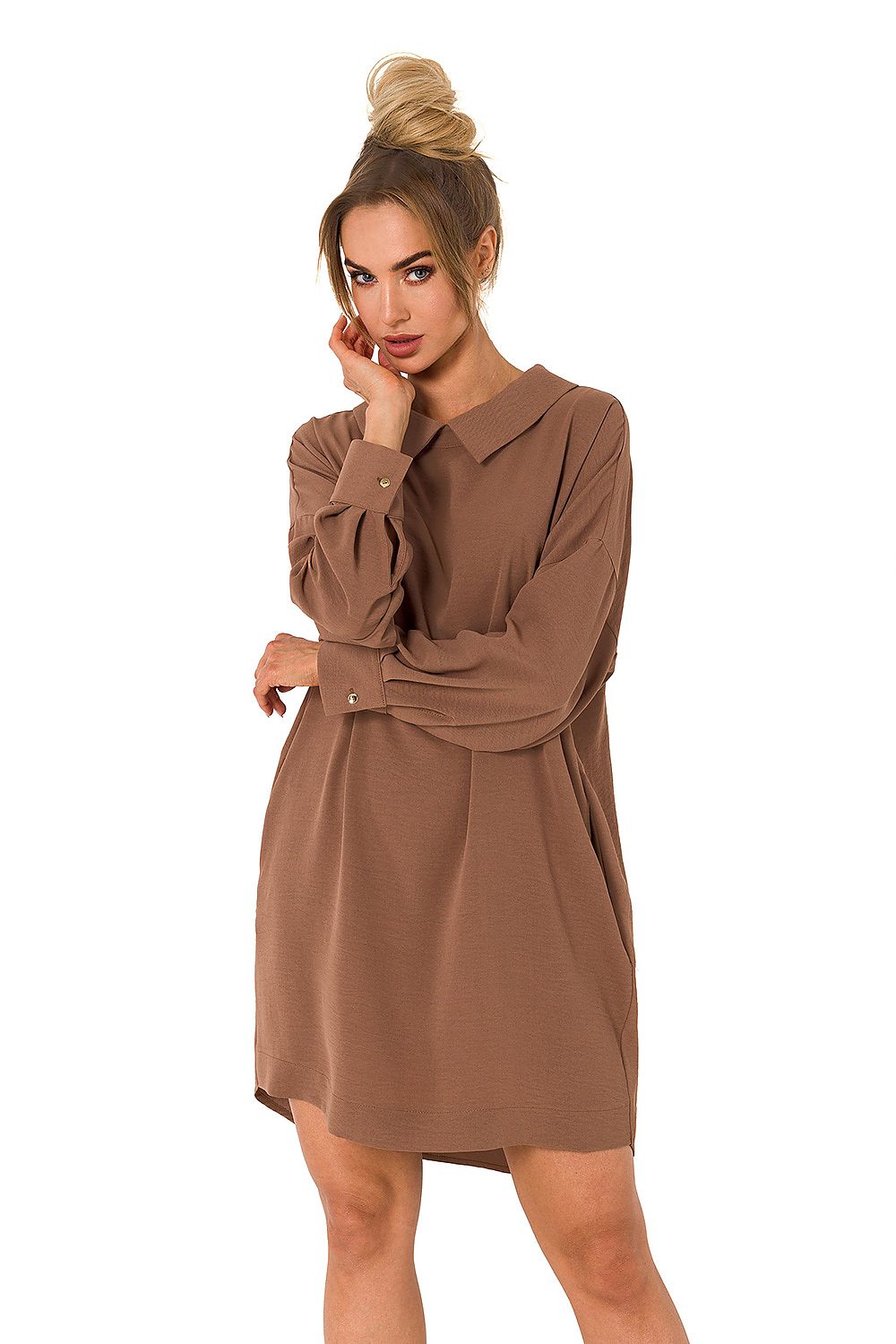 Woman wearing a brown dress on a white background