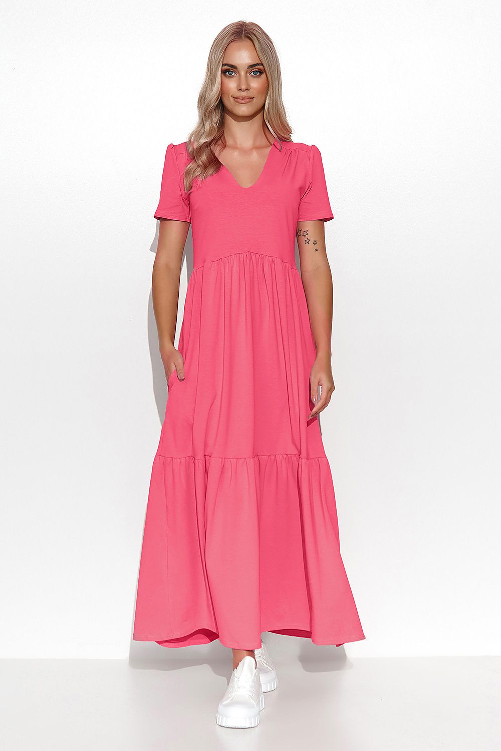 Woman wearing a pink dress on a white background