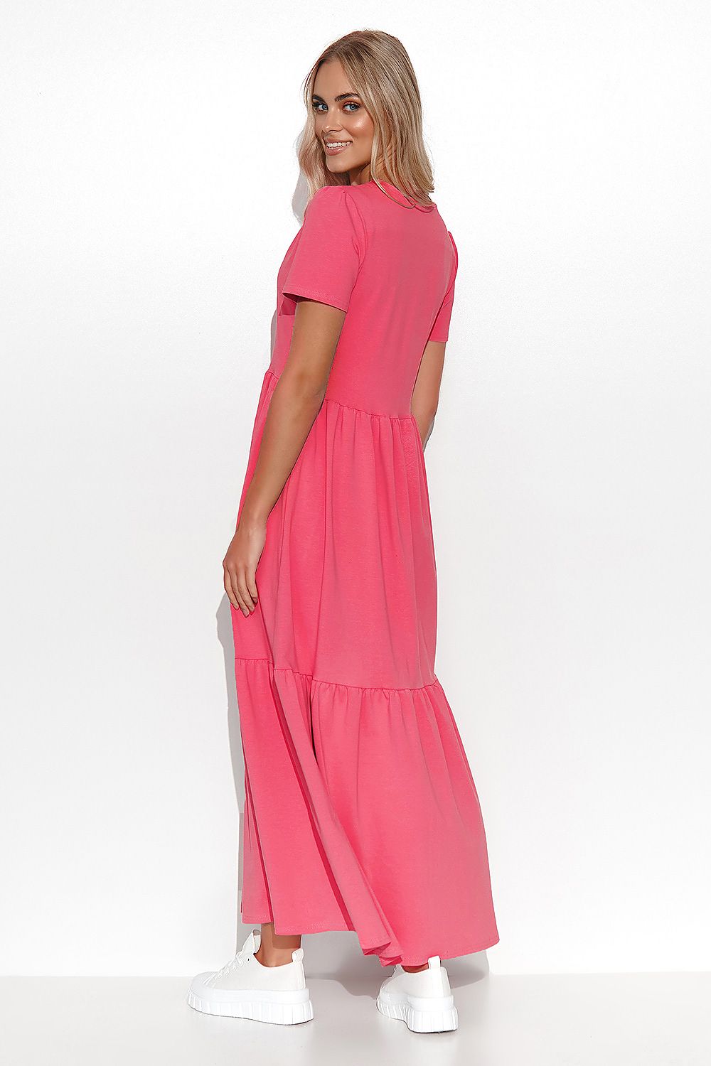 Woman wearing a pink dress on a white background