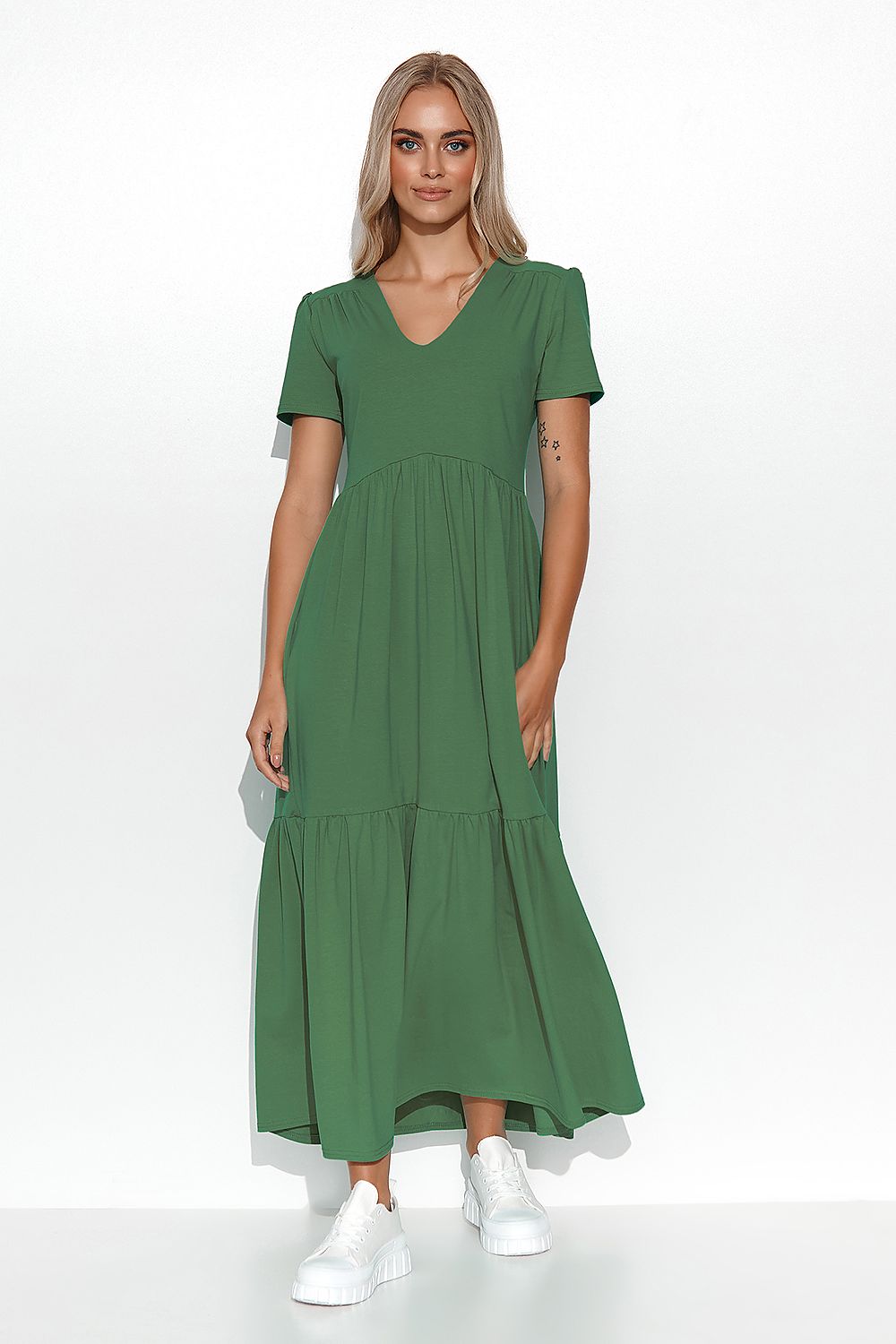 Woman wearing a green dress on a white background