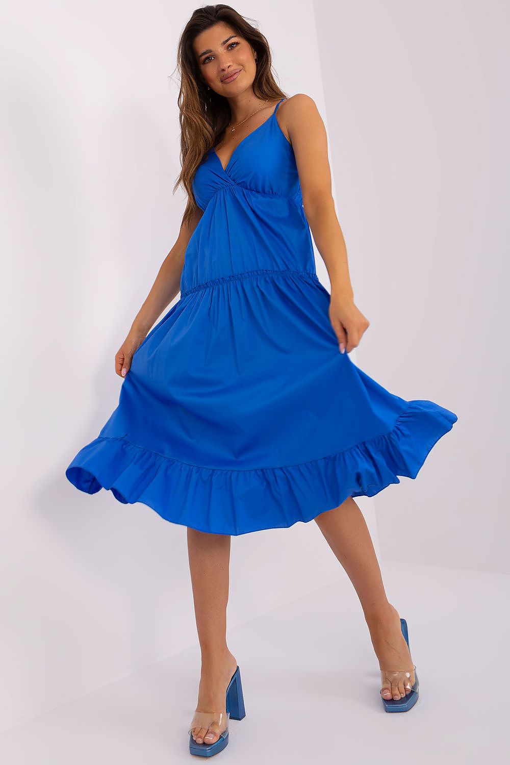 Woman wearing a blue dress against a white background