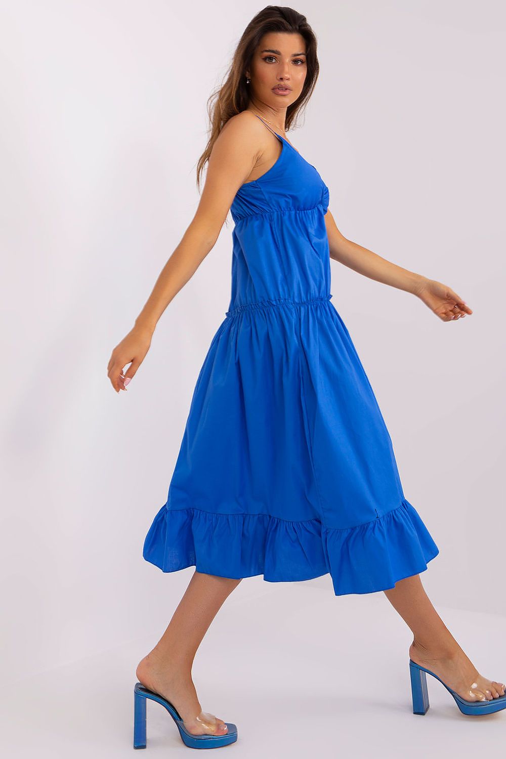 Woman wearing a blue dress on a white background