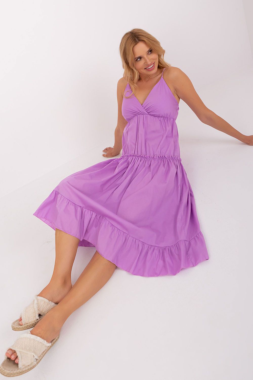 Woman wearing a purple dress on a white background