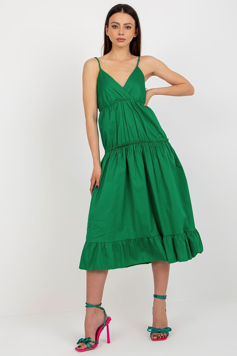 Woman wearing a green dress on a white background