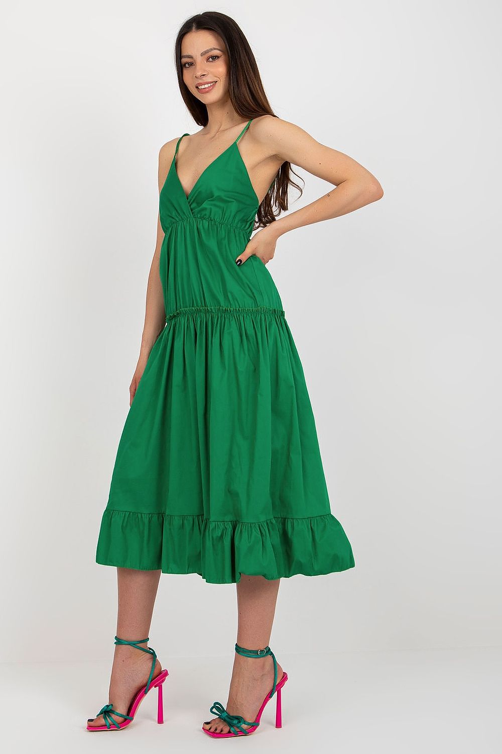 Woman wearing a green dress on a white background