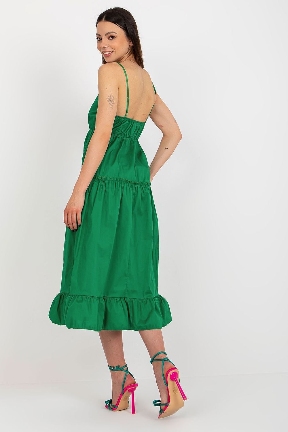Woman wearing a green dress with a white background