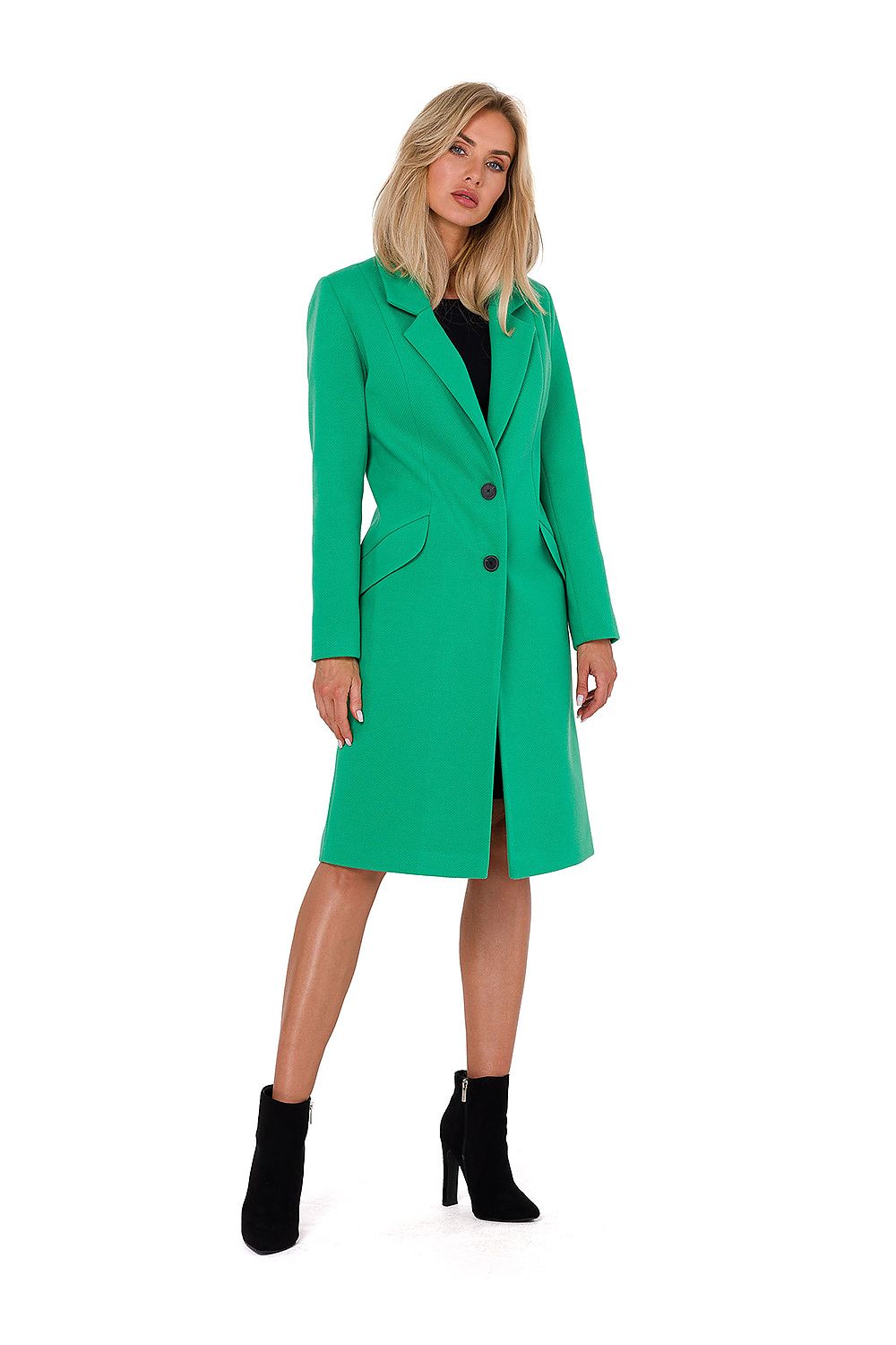 Woman wearing a green coat on a white background