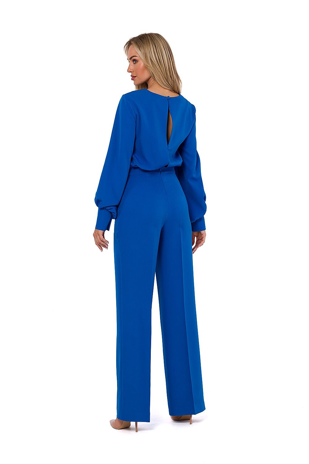 Woman wearing a blue jumpsuit on a white background