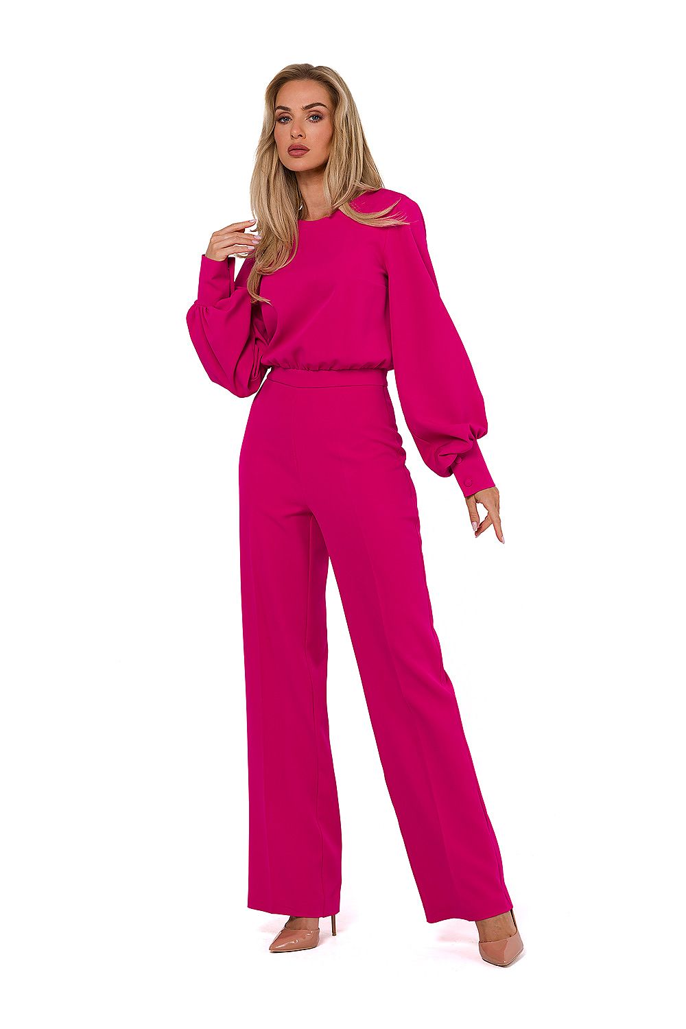 Woman wearing a bright pink outfit on a white background