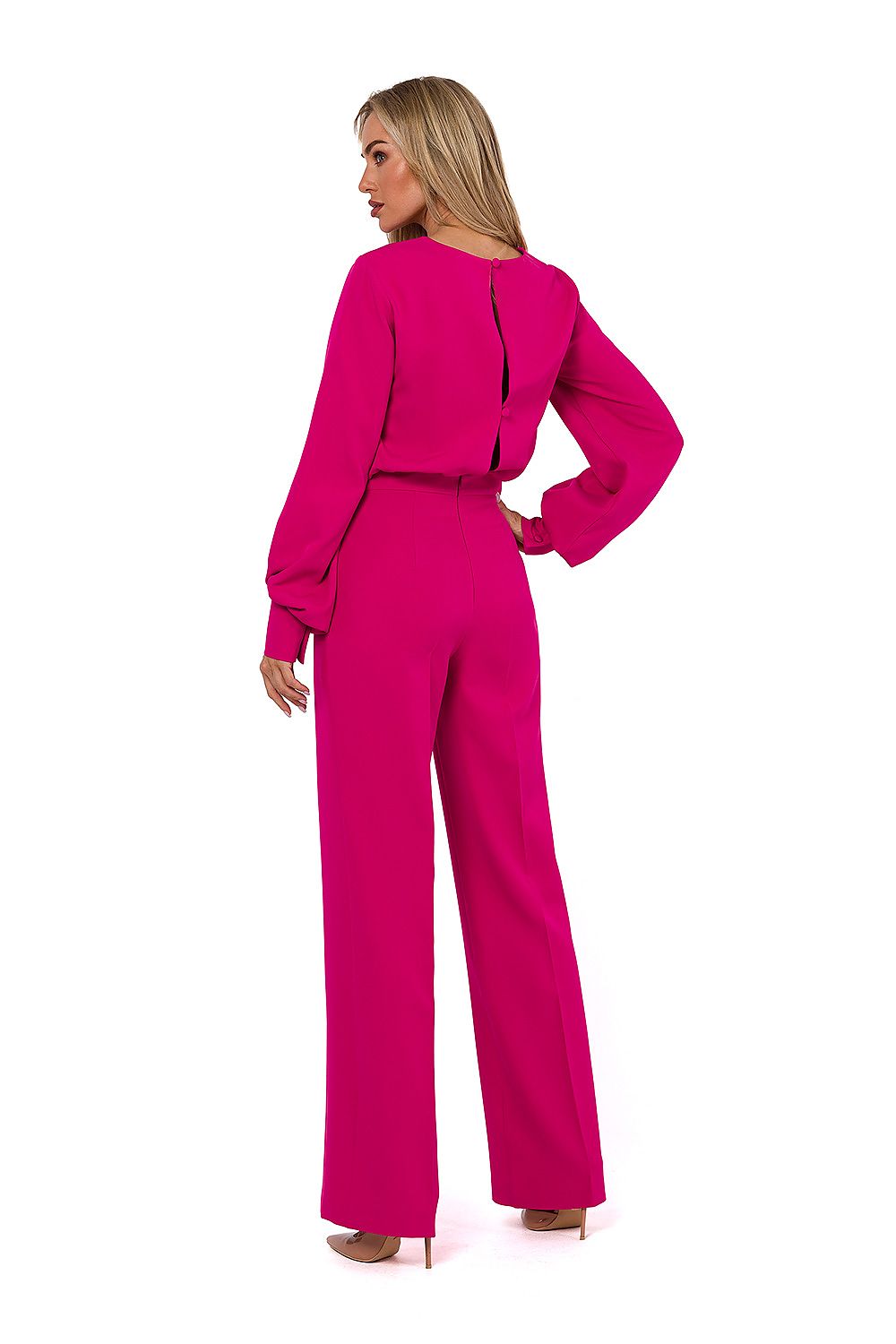 Woman wearing a bright pink outfit on a white background