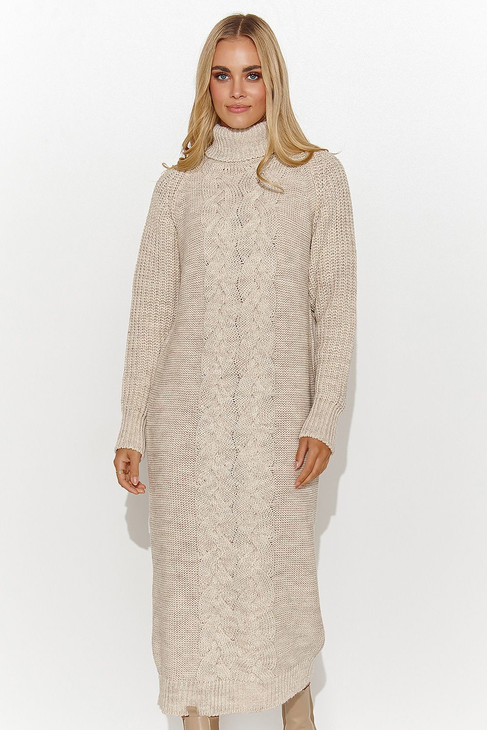 Woman wearing a beige cable knit dress on a white background