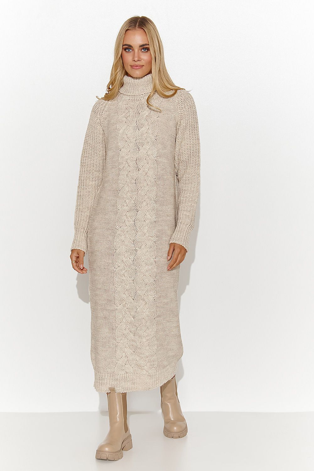 Woman wearing a long beige knitted dress on a white background