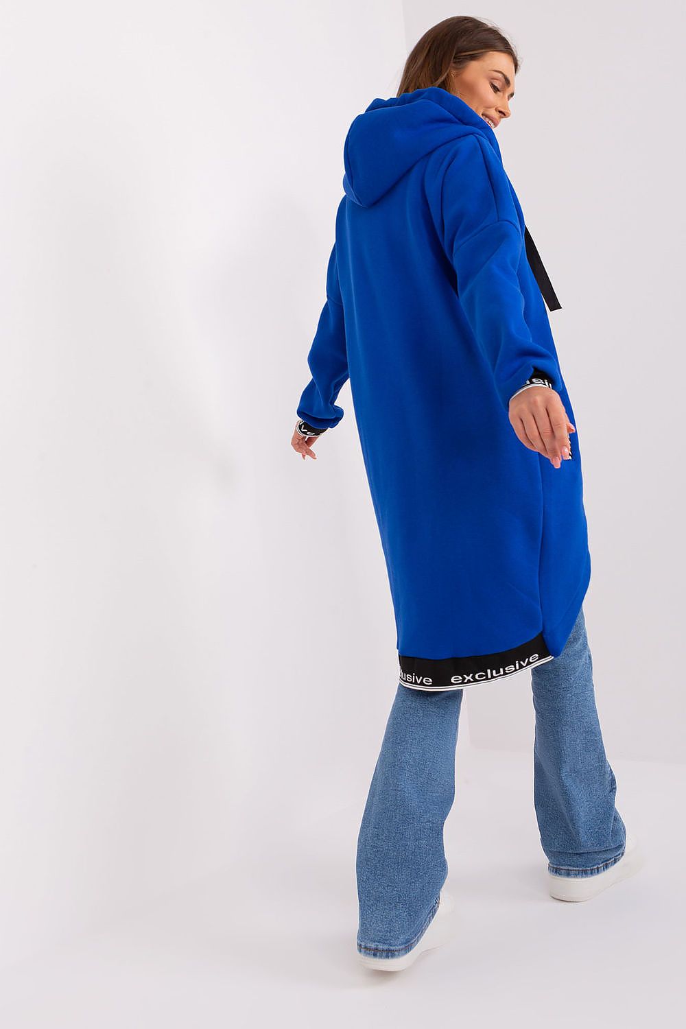 Person wearing a blue hoodie and jeans on a white background