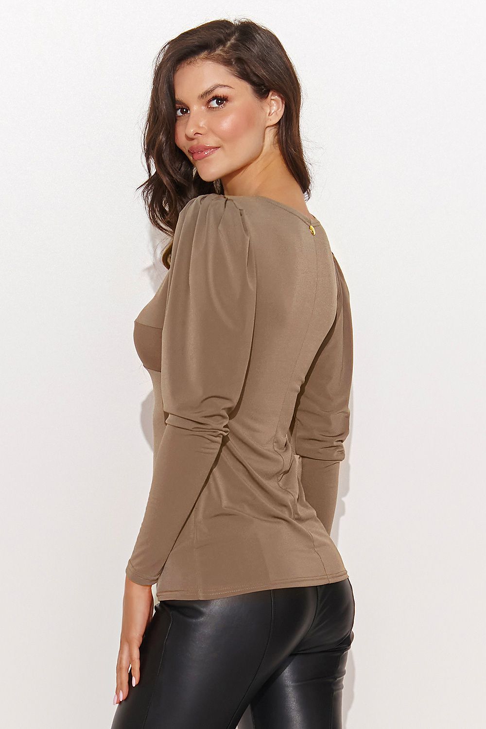 Woman wearing a brown top with a white background