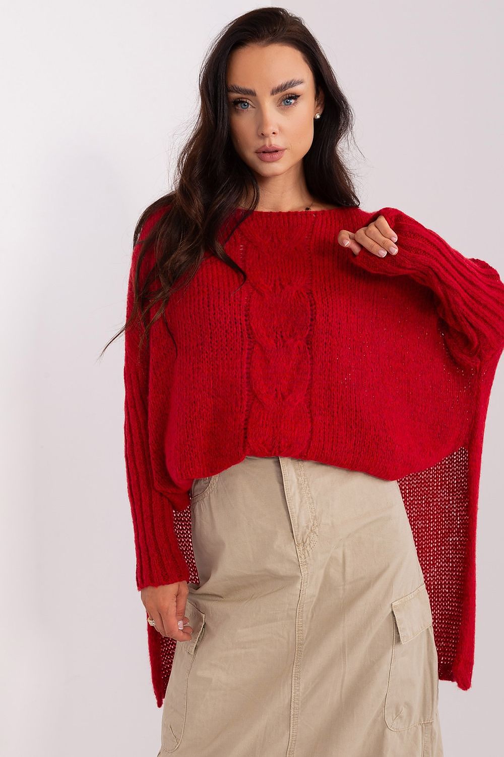 Woman wearing a red sweater with a white background
