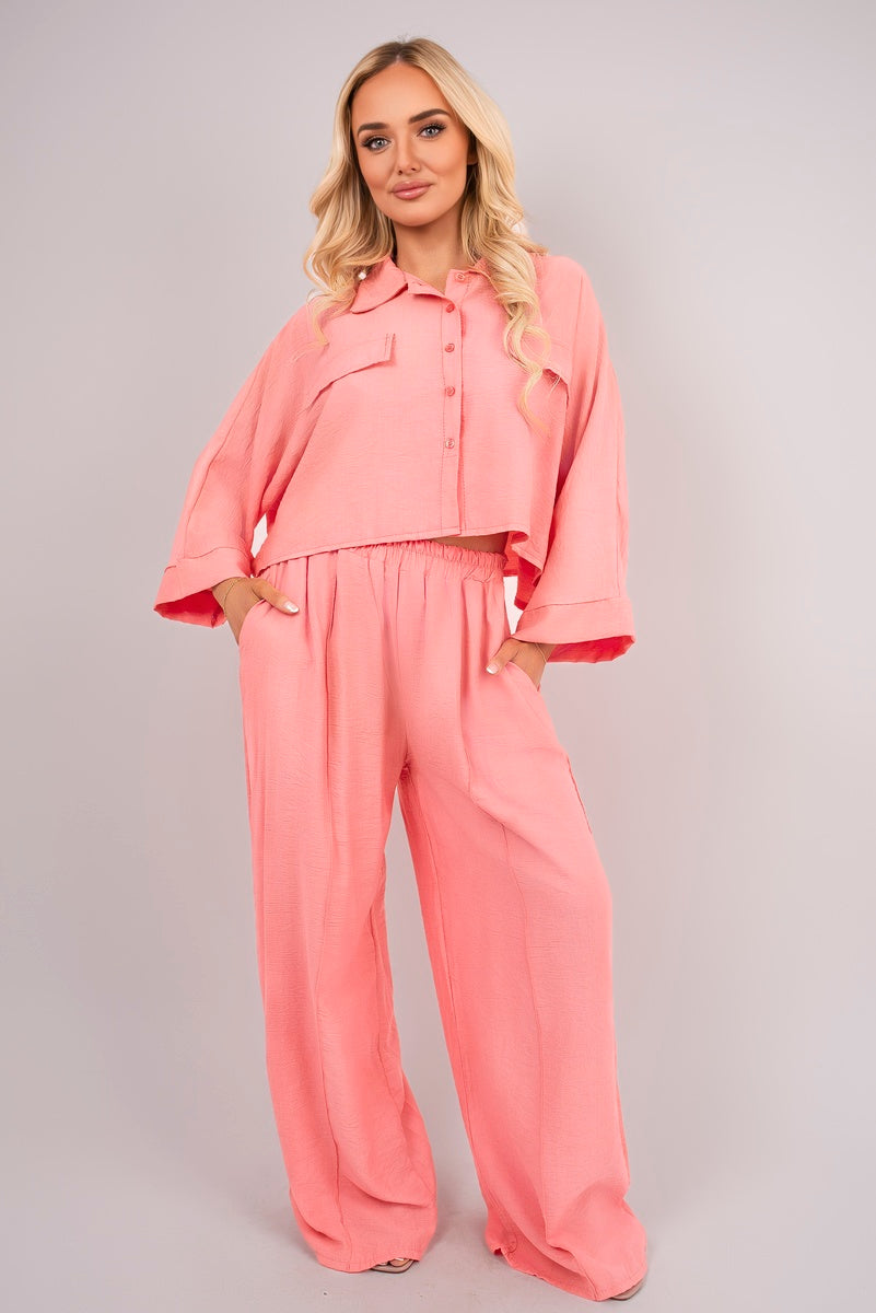 Front view of coral oversized crop top & wide-leg trousers co-ord set.